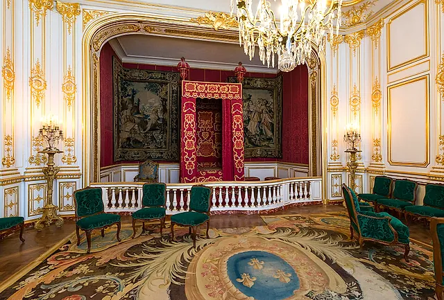 The King's Bedchamber at Château de Chambord, with its red canopied bed and chandelier